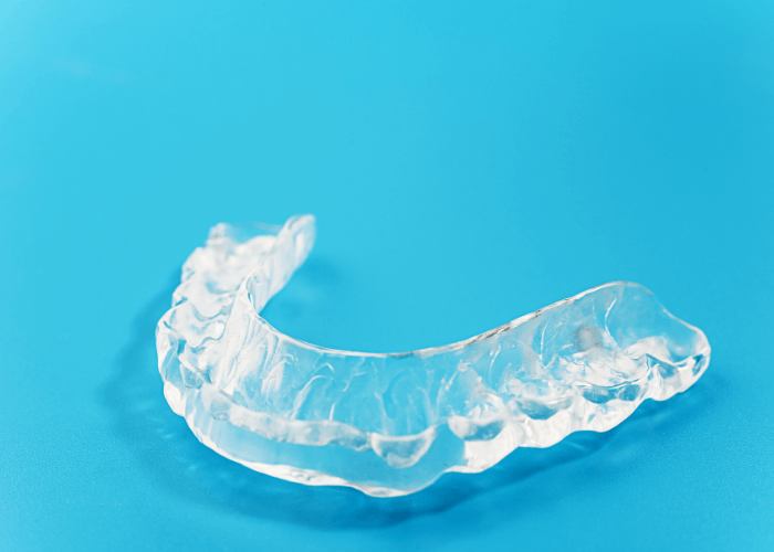 image of a sleep apnea oral appliance on a blue background