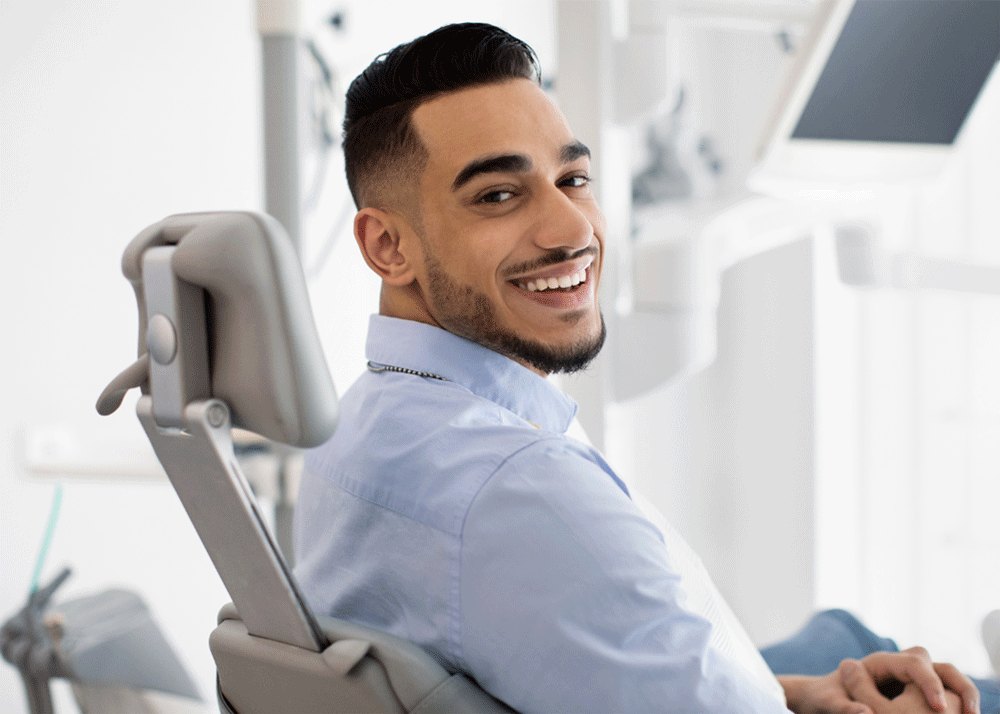 Image of a man sitting in a dental chair smiling